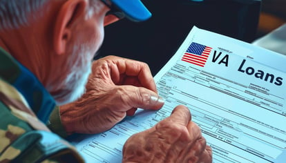 A veteran applying for a VA loan and looking closely at a piece of paper.