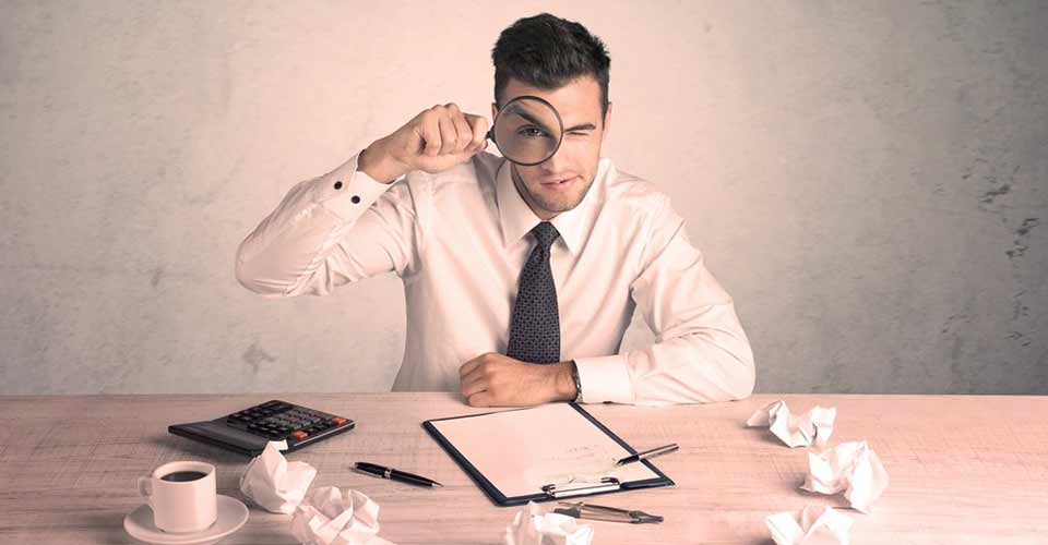 A young person sitting at desk working with document